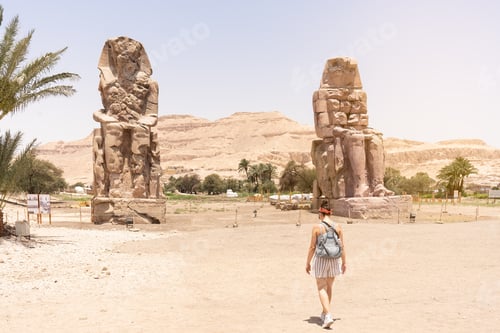 Preview: Woman walking towards an ancient egyptian statues