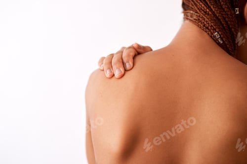 Preview: Studio shot of an unrecognizable woman touching her shoulder