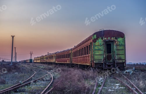 Preview: Old rusty train on the rails during sunset