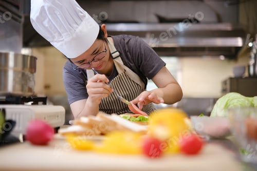 Preview: Focused chef carefully a gourmet sandwich in a professional kitchen with fresh ingredients in view