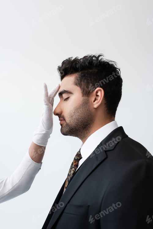 Preview: bride in white glove touching forehead of groom during wedding ceremony isolated on grey