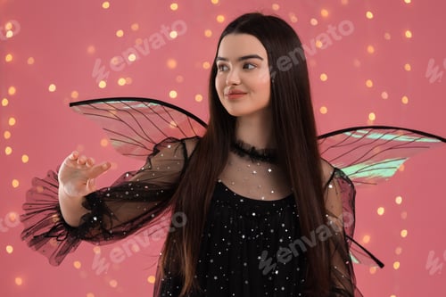 Preview: Beautiful girl in fairy costume with wings on pink background