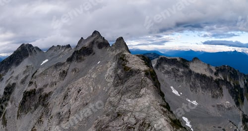 Preview: Rugged Mountain Ridge Above Snow Patches in British Columbia, Canada