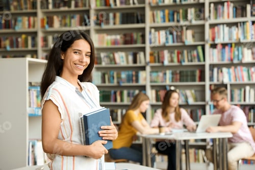 Preview: Happy young woman with books in library. Space for text