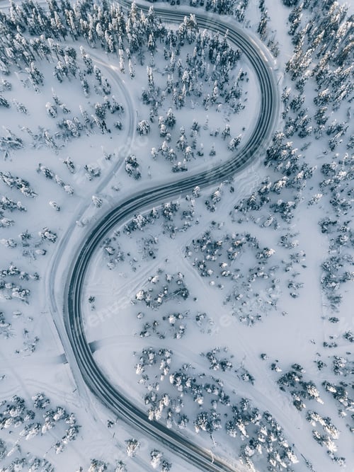 Preview: Aerial view of winter road in the forest covered with snow, Finland Lapland