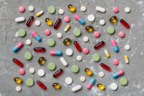 Preview: Many different pills and space for text on colorful background, top view. Different pills