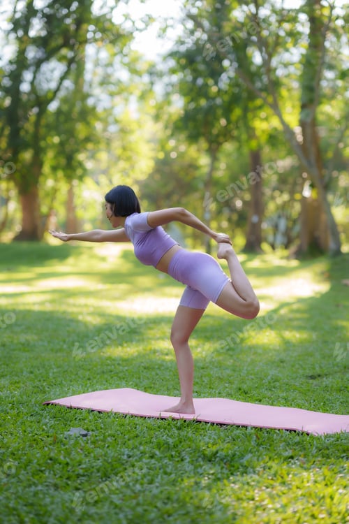 Preview: Yoga in the park. Young Asian woman practicing yoga pose at the park.