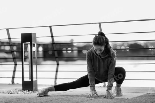 Preview: Woman Stretching on Walkway in an Urban Area