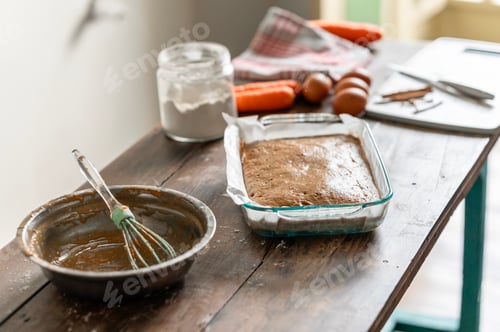 Preview: Preparing a carrot cake on a rustic wooden table
