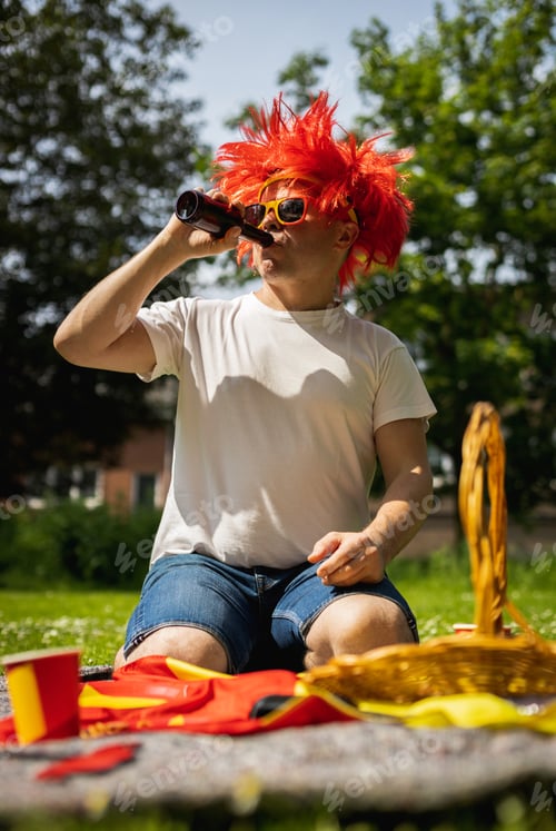 Preview: Portrait of a young man with beer celebrating belgium day.