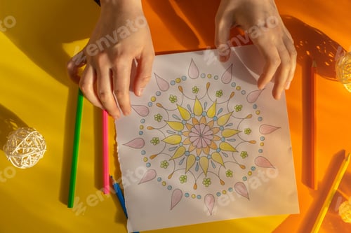Preview: Female painting mandalas antistress page to combat stress. Relaxing hobby mental wellbeing and art