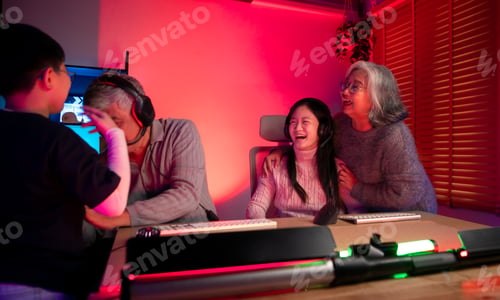 Preview: Happy grandparents playing games with grandchildren in in a neon lit room
