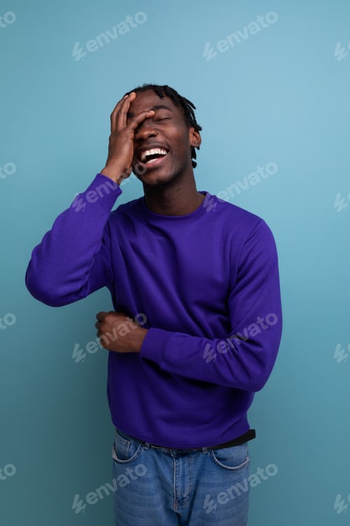 Preview: positive black american young guy with dreadlocks smiling and joking