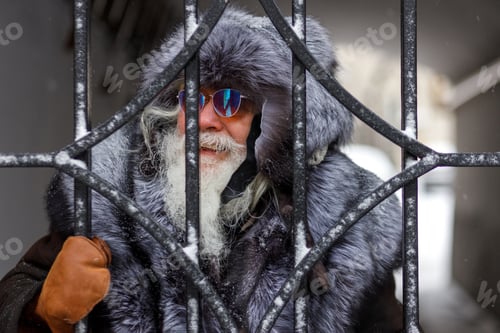Preview: An elderly gray-haired man with a magnificent mustache.A stylish hipster wearing a fur hat and coat