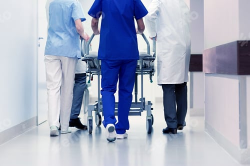Preview: medics carrying hospital gurney to emergency room