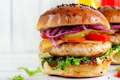 Preview: Sandwich with chicken burger, tomatoes, cheese, pickled cucumber and lettuce. Cheeseburger.