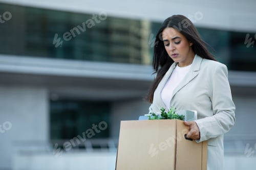 Preview: Jobless arabic businesswoman unhappily walking away office carrying belongings box
