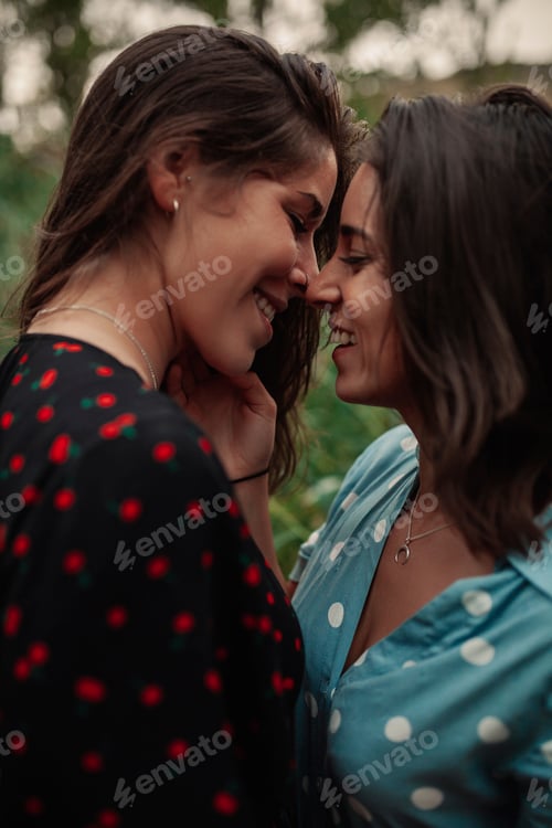 Preview: Two young women embraced on the field