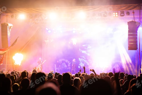 Preview: Crowd at concert and blurred stage lights.