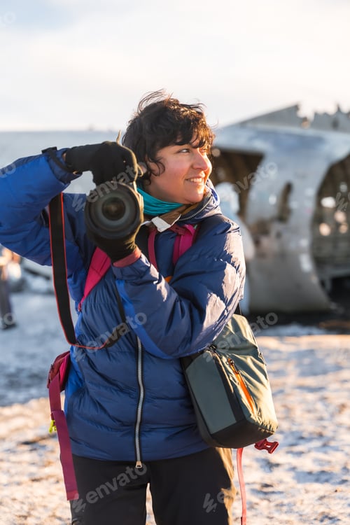 Preview: Portrait of adventurous photographer woman in winter in Iceland on the plane by Solheimasandur