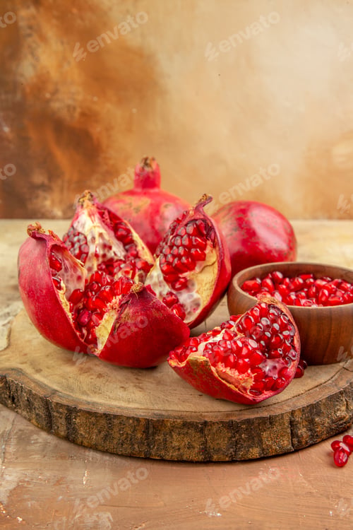 Fresh Pomegranates on a Wooden Board