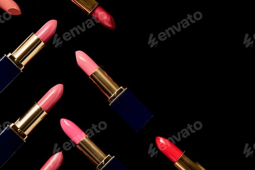 Preview: flat lay with various shades of lipsticks isolated on black with copy space