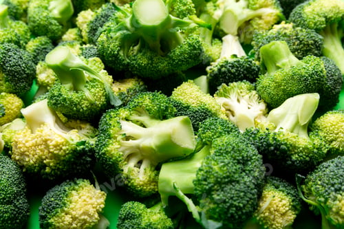 Preview: green fresh broccoli background close up on colored table. Vegetables for diet