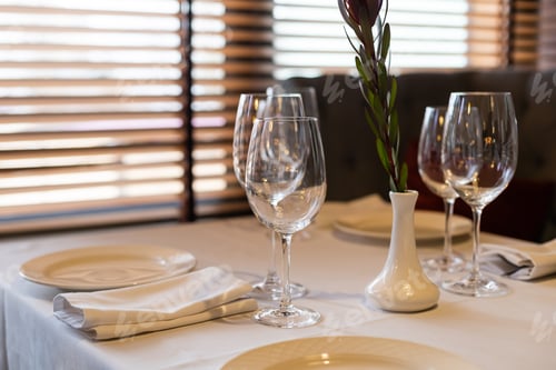 Preview: beautifully laid tables with glasses and appliances at morning in restaurant