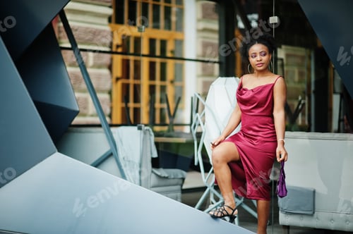 Preview: Black model in red silk dress.