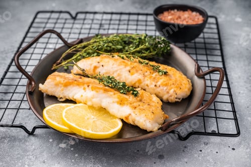 Preview: Baked Cod fish fiilet, fried whitefish meat. Grey background. top view