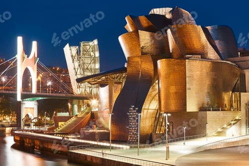 Preview: Bilbao downtown Guggenheim museum titanium metallic facade by night. Spain