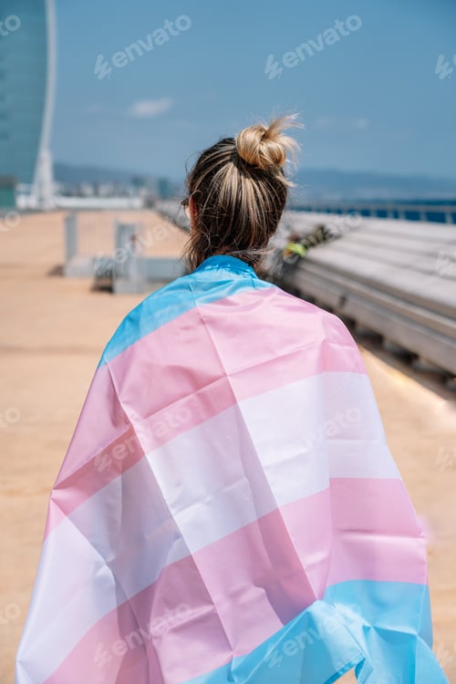 Preview: transsexual woman with trans flag, holding a transgender pride flag