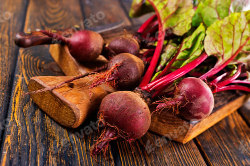 Preview: fresh beets on cutting board, set on wooden table viewed from above