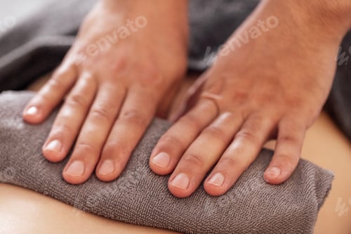 Preview: Close-up of neat male masseur hands lying on a towel. A massage therapist