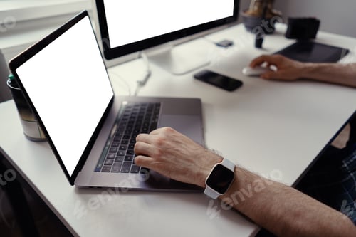 Preview: Man hands working on laptop with white screen at home