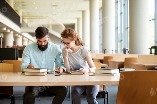 Preview: Happy group of success students studying and working together in a college library