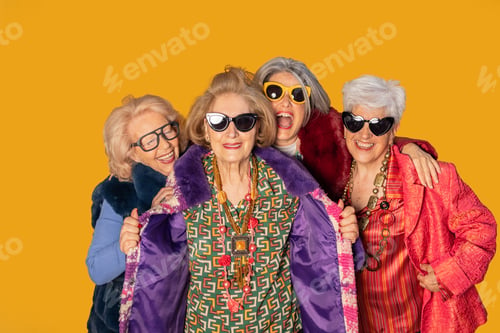 Preview: Four stylish senior women smiling and having fun together