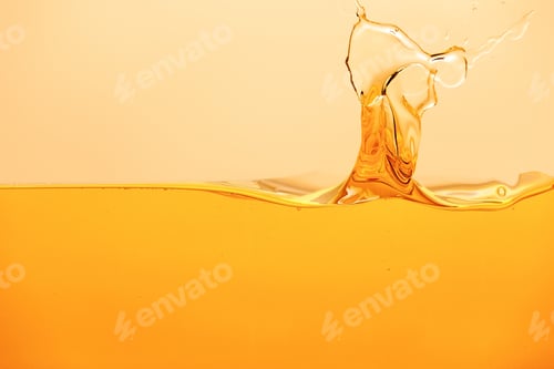 Preview: yellow bright liquid with splash isolated on yellow