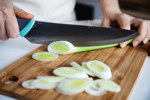 Preview: Chef Slicing Leek on Bamboo Cutting Board