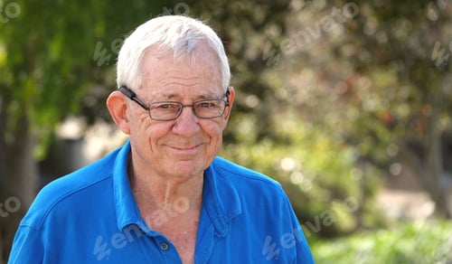 Preview: Shallow focus of an elderly smiling Caucasian man wearing eyeglasses with a kind facial expression