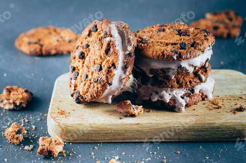Preview: Chocolate Ice cream sandwiches and chocolate chip cookies on wooden board