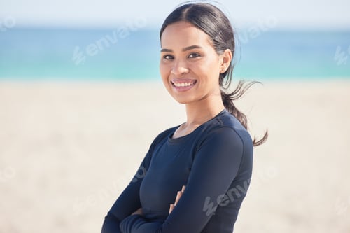 Preview: Arms crossed, beach and portrait of happy woman by the ocean ready for surf, exercise and workout.