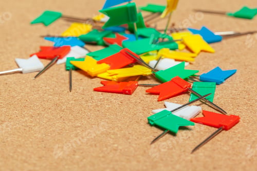 Preview: Mini flags thumbtacks over corkboard background close up