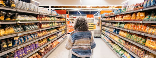 Preview: Woman making choices in supermarket snack aisle