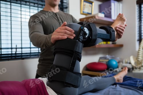 Preview: Male physiotherapist giving leg massage to patient