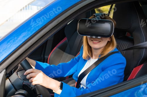 Preview: Smiling woman sitting in the car in VR goggles.