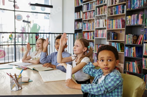 Preview: Multi-ethnic pupils study and write at table in library or classroom. Back to school.