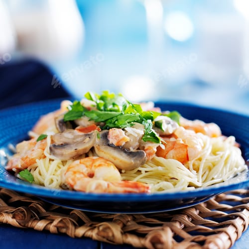 Preview: angel hair shrimp pasta in champagne sauce with mushrooms on blue plate