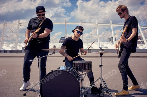 Preview: rock band in black clothing playing music on street