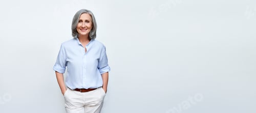 Preview: Smiling mature business woman standing isolated on white background, banner.